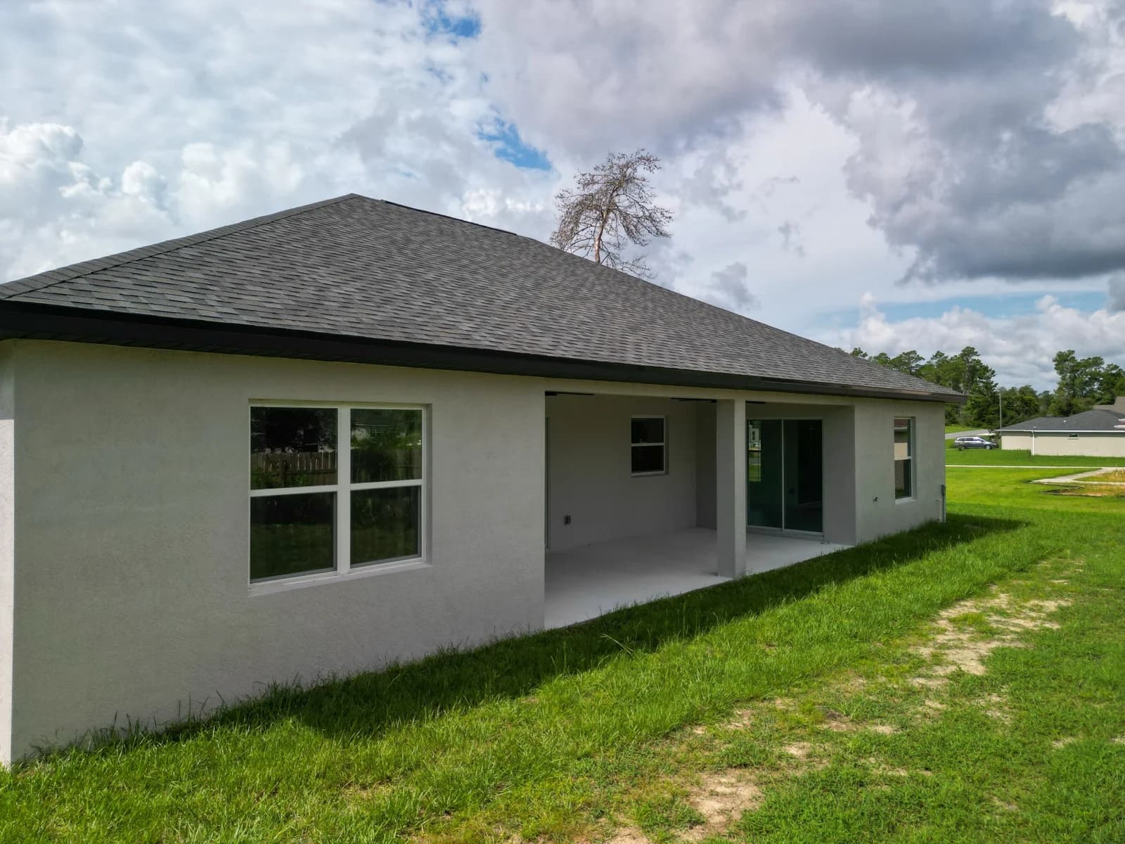 Covered rear patio and backyard of a single-story Florida listing